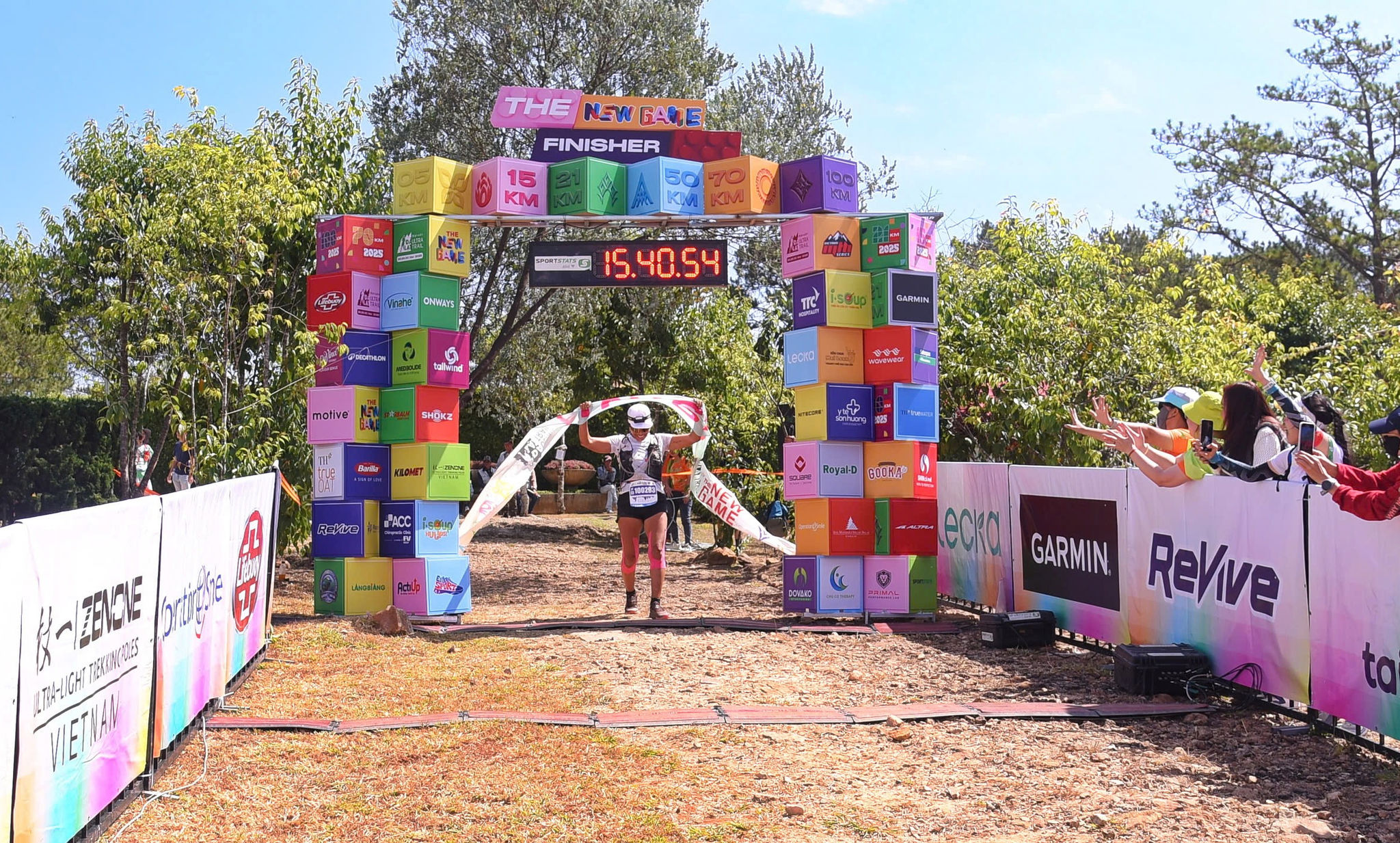 A runner reaches the finish at Dalat Ultra Trail 2025.