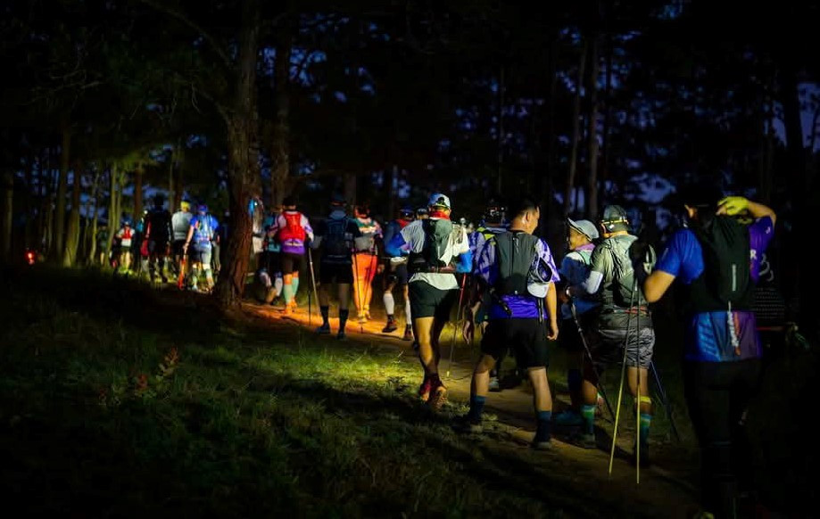 Historical Dalat Ultra Trail photograph: runners on a forest trail at night; edition year not stated.